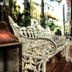 Be Playa Hotel Boutique & Rooftop Bar in Playa del Carmen, ornate white bench beside a lantern in a garden setting