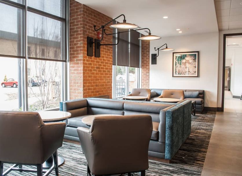 Hyatt Place Blacksburg/University lobby seating area with large windows and modern lounge chairs