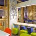 Ibis Budget Givet lobby with colorful seating, tables, and patterned wall art