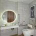 DoubleTree by Hilton Hull bathroom with walk-in shower, wall-mounted toilet, and round backlit mirror