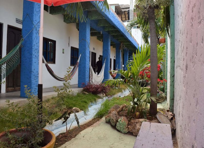 Casa Torices Real 12 in Cartagena courtyard with hammocks, blue columns, and tropical plants