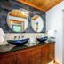 Little Creek Cove Beach Resort Newport bathroom with double vanity, mirrors, glass shower and soaking tub