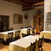 Hotel del Vasco in Zacatecas dining room with wooden chairs, set tables, and rustic beams