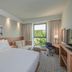 Hampton by Hilton Oswiecim room with king bed, sofa, desk, TV and window view in Oświęcim