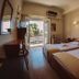 Hotel King Pyrros in Ioánnina twin room with balcony and open door to wooded view
