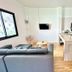 The Scenery Beach Resort in Ko Pha Ngan: modern open-plan suite with sofa, kitchen island and wall TV