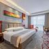 Yichang Guobin Bandao Hotel guest room with king bed, desk, chair and city-view window in Yichang