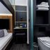 The Z Hotel Holborn in London, compact room with bed, TV, desk, sink and toilet area