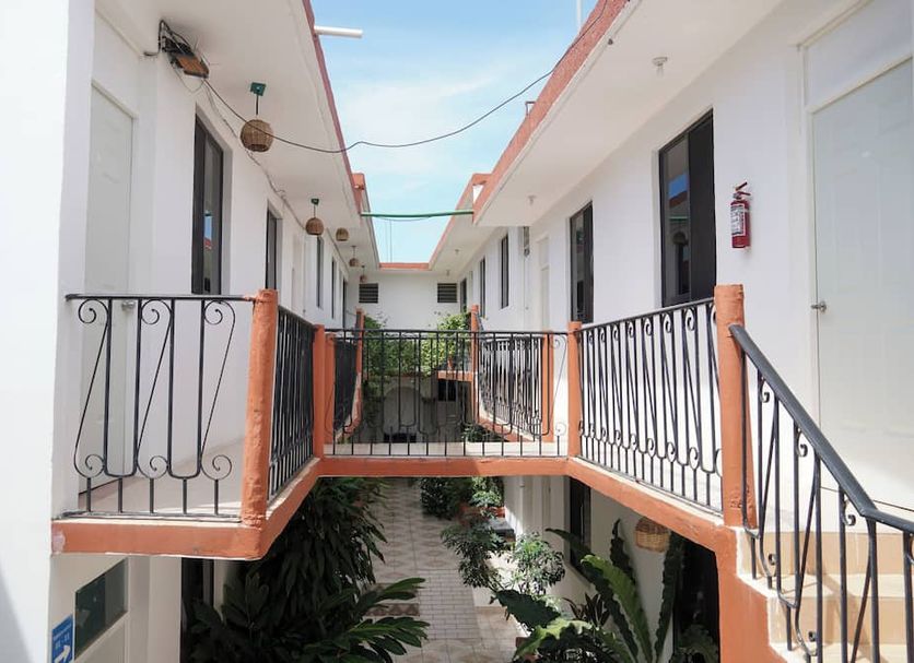 OYO Hotel Arena Surf, Puerto Escondido corridor with second-floor balconies and courtyard view