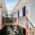 OYO Hotel Arena Surf, Puerto Escondido corridor with second-floor balconies and courtyard view