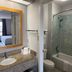 Motel 6 Laurel, MS bathroom with granite vanity, mirror, toilet, and shower tub combo