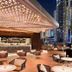 Hotel Indigo Dubai Downtown By IHG rooftop terrace with bar seating and Dubai skyline at night