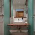 Familien- & Vitalhotel Auenhof in Fulpmes bathroom sink with open teal stall doors and shower area