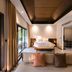 ananea Beyond Khaolak in Takua Pa: modern bedroom with king bed and sliding doors to a pool view