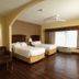 Holiday Inn Express & Suites Seguin by IHG guest room with two beds, sofa and large window