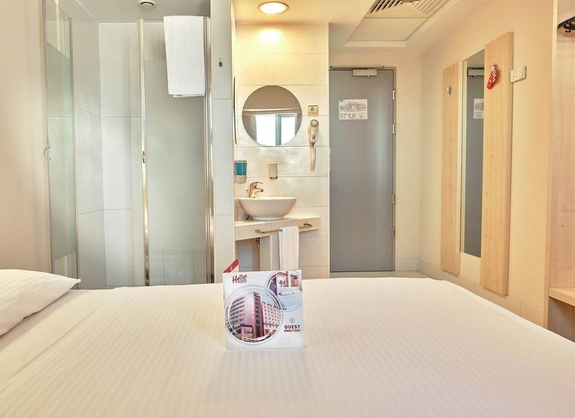 Hello Hotels Bucuresti Gara de Nord room in Bucharest with bed, shower, sink, and bathroom door