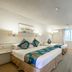 Twin Towers Inn Artarmon guest room with two beds, desk seating and large windows with natural light
