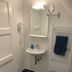 Zum armen Mann hotel bathroom in Düsseldorf with wall-mounted sink, mirror, towel warmer, and shower hose
