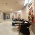 Thotel Lamezia lobby lounge in Feroleto Antico with curved steps, seating area, and colorful wall art