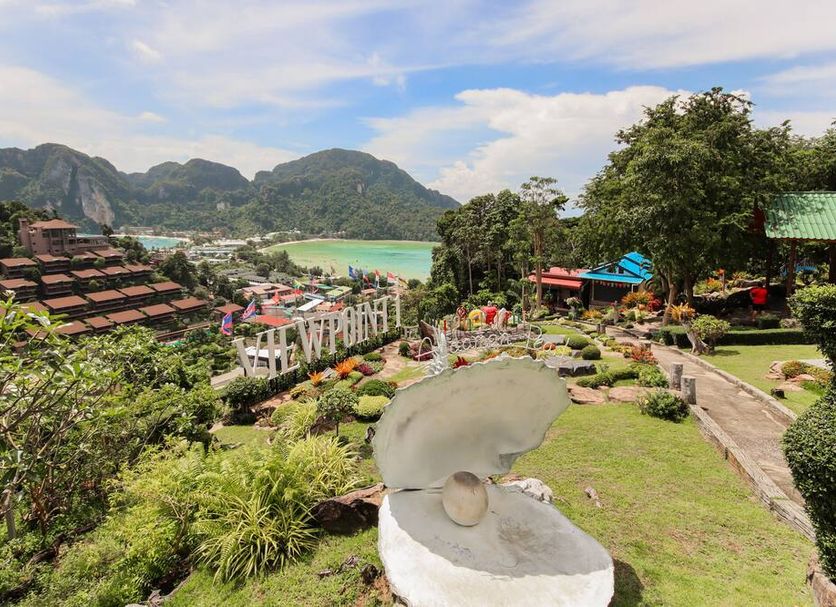 OYO 1103 Pirates House Hotel in Ko Phi Phi with tropical garden, sea view, and mountain backdrop