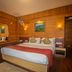 Hotel Jagjeet, Darjeeling bedroom with double bed and wood-paneled walls