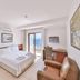 Gardenia Hotel in Kaş guest room with balcony sea view, desk, chair and armchair