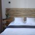 Hôtel En Ville in Aix-en-Provence room with double bed, striped headboard and bedside table