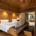 ananea Beyond Khaolak, Takua Pa: wooden suite with bed, sofa, desk and open bathroom view