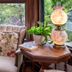 1899 Wright Inn & Carriage House in Asheville: floral armchair beside a wooden table and lamp by a window