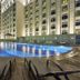 Haili Garden Hotel, Guangzhou: outdoor rooftop pool and lounge chairs beside the hotel at night