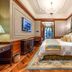 Moller Villa Hotel Shanghai guest room with ornate decor, chandelier, canopy bed, and patterned rug