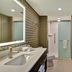 Home2 Suites by Hilton Orlando at FLAMINGO CROSSINGS Town Center bathroom with vanity, walk-in shower, and toilet