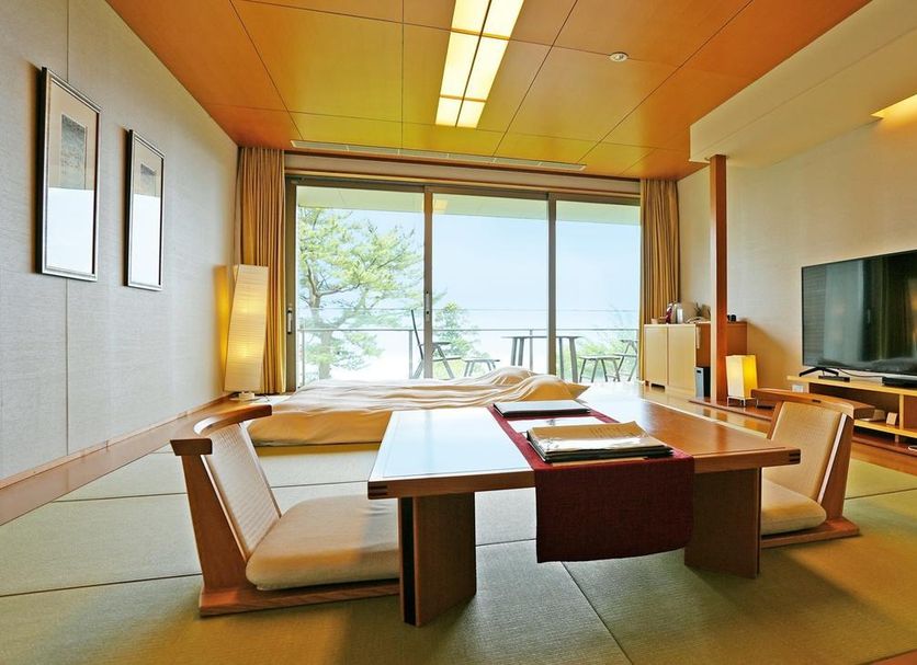 Atami Club Geihinkan in Atami suite with tatami seating and ocean-view balcony