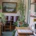 Historic Smith Hotel B&B in Glendale sunroom corridor with abundant potted plants and bench seating