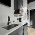 Balboa Park Hotel San Diego kitchen nook with sink, black fixtures, mini fridge and dark door