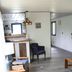 Denali RV Park and Motel in Healy: simple seating area with chair, side table, and open kitchenette