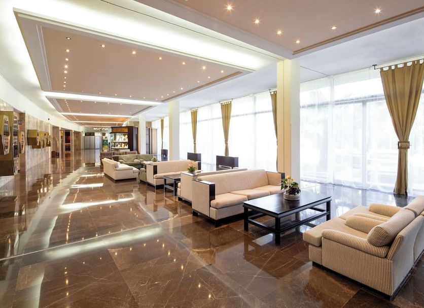 Corfu Holiday Palace lobby in Kanoni with bright seating area and polished marble floors