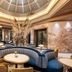 BLESS Hotel Madrid lobby with blue curved seating, round tables, marble walls and a domed ceiling