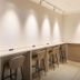 Daiwa Roynet Hotel Sendai workspace with high stools and counters in a minimalist room