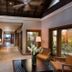 Constance Belle Mare Plage lobby corridor with stone wall, ceiling fan and seating in Belle Mare