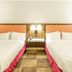 Hampton Inn Garden City guest room with two double beds and a small bedside table