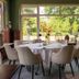 Van der Valk Hotel Hardegarijp - Leeuwarden dining room with round tables and large garden-view windows