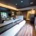 Livemax Resort Aki Miyajima room in Hatsukaichi with twin beds and sliding glass doors to a balcony
