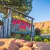 Red Stone Inn in Moab sign beside desert rocks and mountains