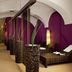 Mercure Grand Hotel Biedermeier Wien spa lounge in Vienna with purple walls and wicker seating