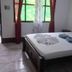 Cabinas Tortuguero Natural room in Tortuguero with double bed, folded towels, and window view