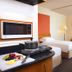 J5 Hotels Port Saeed Dubai room with two beds, seating area, and kitchenette