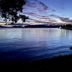 Anchor Lodge Motel in Coromandel with tranquil waterfront view at dusk and colorful sunset sky