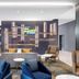La Quinta Inn & Suites by Wyndham La Habra lobby with seating area and neon sign in La Habra