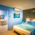 El Navegante de Culebra room with king bed, air conditioner, and ensuite bathroom doorway in Culebra